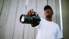 A photographer showing off his camera
