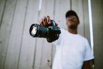A photographer showing off his camera