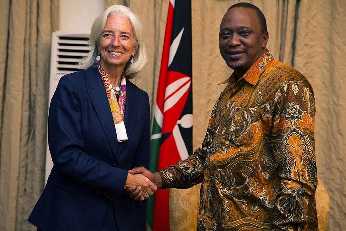 International Monetary Fund Managing Director Christine Lagarde (L) shakes hands with President Uhuru Kenyatta (R) at the State Lodge prior to a dinner on January 6, 2014 in Mombasa Kenya. AFP PHOTO / IMF /Stephen Jaffe
