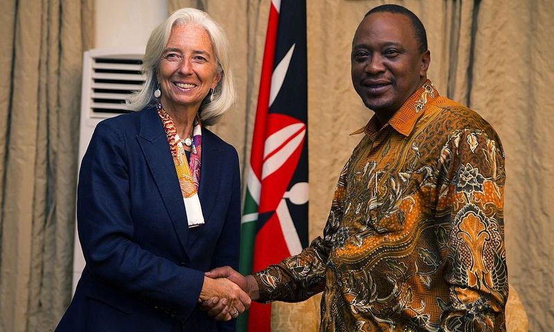 International Monetary Fund Managing Director Christine Lagarde (L) shakes hands with President Uhuru Kenyatta (R) at the State Lodge prior to a dinner on January 6, 2014 in Mombasa Kenya. AFP PHOTO / IMF /Stephen Jaffe