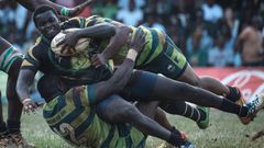 TOPSHOT - Kabras Sugar's Johnston Mungau (C) is tuckled by Kenya Commercial Bank's Brian Omondi (L) and Peter Kilonzo during the Kenya Cup's final match between Kenya Commercial Bank and Kabras Sugar at the KCB Sports Club in Nairobi, on March 24, 2018...