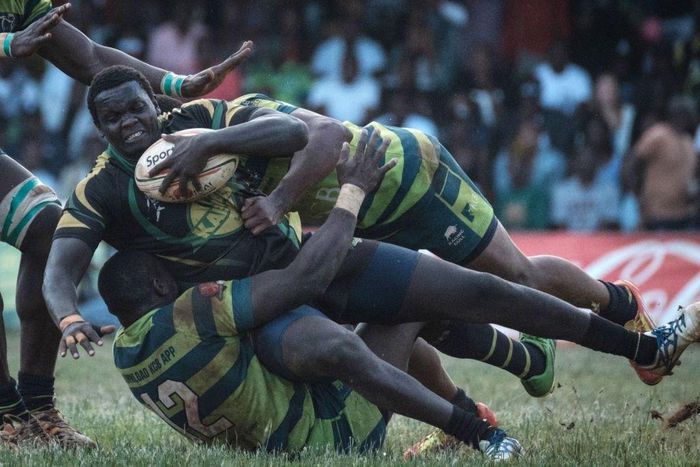 TOPSHOT - Kabras Sugar's Johnston Mungau (C) is tuckled by Kenya Commercial Bank's Brian Omondi (L) and Peter Kilonzo during the Kenya Cup's final match between Kenya Commercial Bank and Kabras Sugar at the KCB Sports Club in Nairobi, on March 24, 2018...