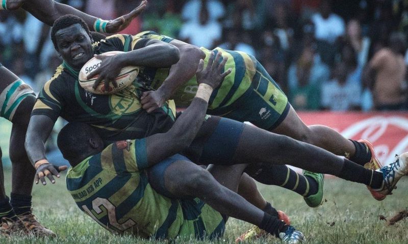 TOPSHOT - Kabras Sugar's Johnston Mungau (C) is tuckled by Kenya Commercial Bank's Brian Omondi (L) and Peter Kilonzo during the Kenya Cup's final match between Kenya Commercial Bank and Kabras Sugar at the KCB Sports Club in Nairobi, on March 24, 2018...