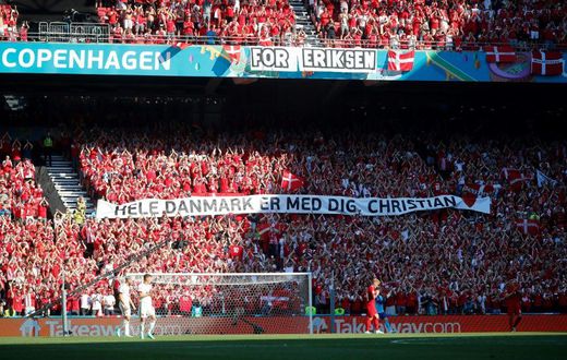 Danish supporters take part in a moment of applause for Christian Eriksen during the Euro 2020 game against Belgium
