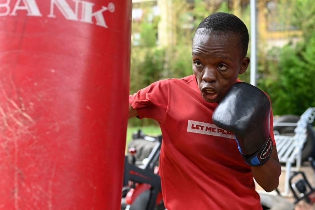 Kenya's boxer Christine Ongare Christine Ongare hits a punching bag during a training session at a gym in Nairobi on June 8, 2021, ahead of the 2020 Tokyo Olympic Games. - A mother at 12, raised in Nairobi's hardscrabble suburbs to survive by her fists...