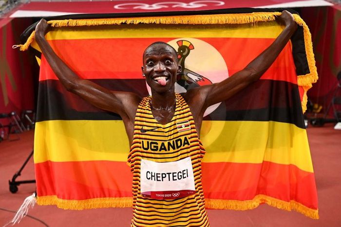TOKYO, JAPAN - AUGUST 06: Joshua Cheptegei of Team Uganda celebrates after winning gold in the Men's 5000m Final on day fourteen of the Tokyo 2020 Olympic Games at Olympic Stadium on August 6, 2021 in Tokyo, Japan. (Photo by Dylan Martinez - Pool / Get...