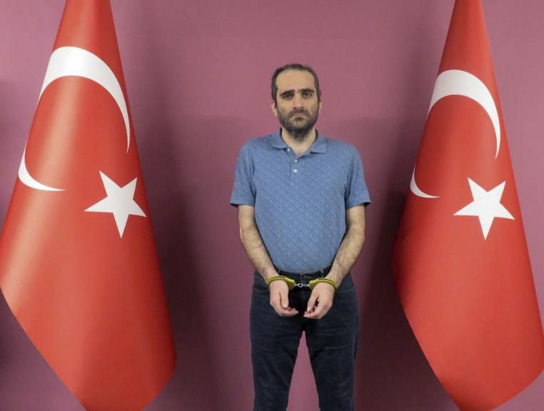 Selahaddin Gulen, a nephew of US-based Muslim cleric Fethullah Gulen, stands between Turkish flags in this photo provided by Turkish intelligence service
