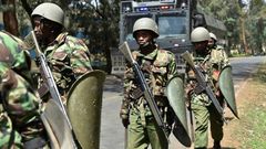 Kenyan riot police patrol a street after dispersing University of Nairobi students protesting in Nairobi on September 28, 2017