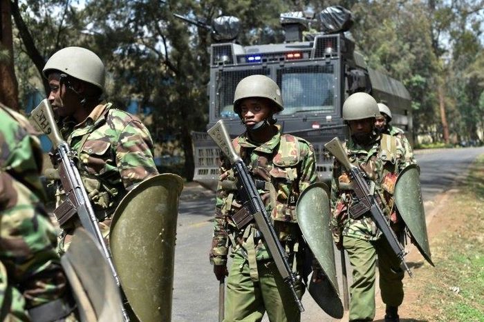 Kenyan riot police patrol a street after dispersing University of Nairobi students protesting in Nairobi on September 28, 2017