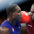 TOKYO, JAPAN - JULY 27: Elly Ajowi Ochola (red) of Kenya exchanges punches with Julio la Cruz of Cuba during the Men's Heavy (81-91kg) on day four of the Tokyo 2020 Olympic Games at Kokugikan Arena on July 27, 2021 in Tokyo, Japan. (Photo by Ueslei Mar...