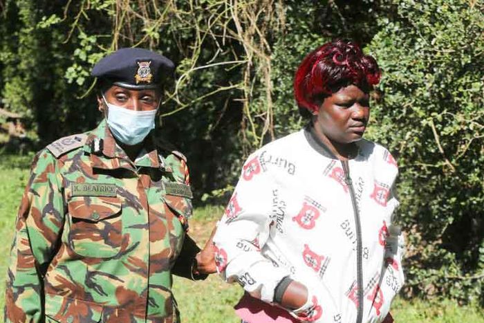 Nakuru County police commander Beatrice Kiraguri condoles Joyce Ndunge, the wife of the Late police constable Bernard Sivo at the Njoro Police station
