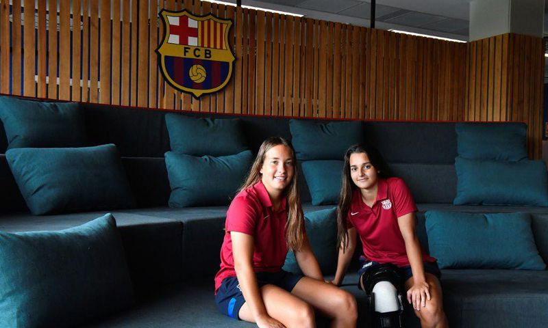 Barcelona's women's B team players Claudia Riumallo Pineda (L) and Laura Coronado pose after a training session at the La Masia Residence