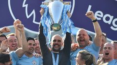 Manchester City manager Pep Guardiola holds up the Premier League trophy