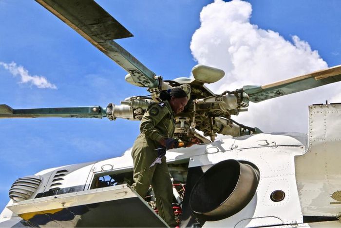Chief Inspector Justine Ouya at work, atop an Mi-17 Police troop carrier.