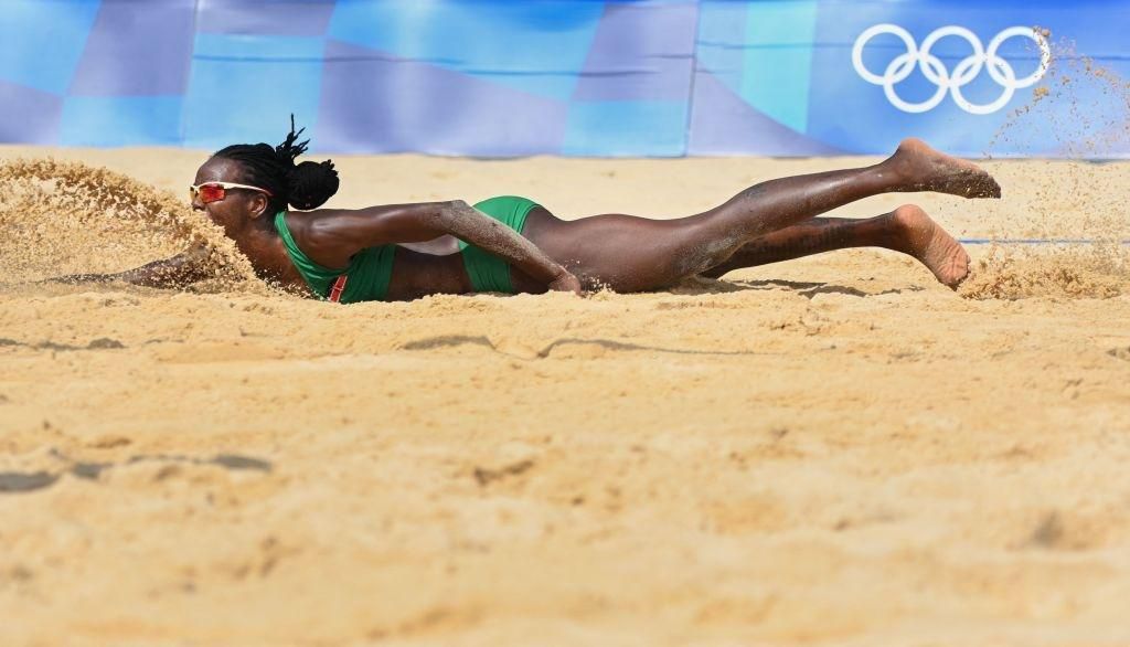 Kenya's Gaudencia Makokha falls in the sand while reaching for the ball in their women's preliminary beach volleyball pool D match between the USA and Kenya during the Tokyo 2020 Olympic Games at Shiokaze Park in Tokyo on July 29, 2021. (Photo by Yuri ...