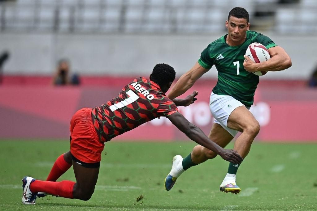 Kenya's Eden Agero (L) tries to tackle Ireland's Jordan Conroy (R) in the men's pool C rugby sevens match between Kenya and Ireland during the Tokyo 2020 Olympic Games at the Tokyo Stadium in Tokyo on July 27, 2021. (Photo by Ben STANSALL / AFP) (Photo by BEN STANSALL/AFP via Getty Images)