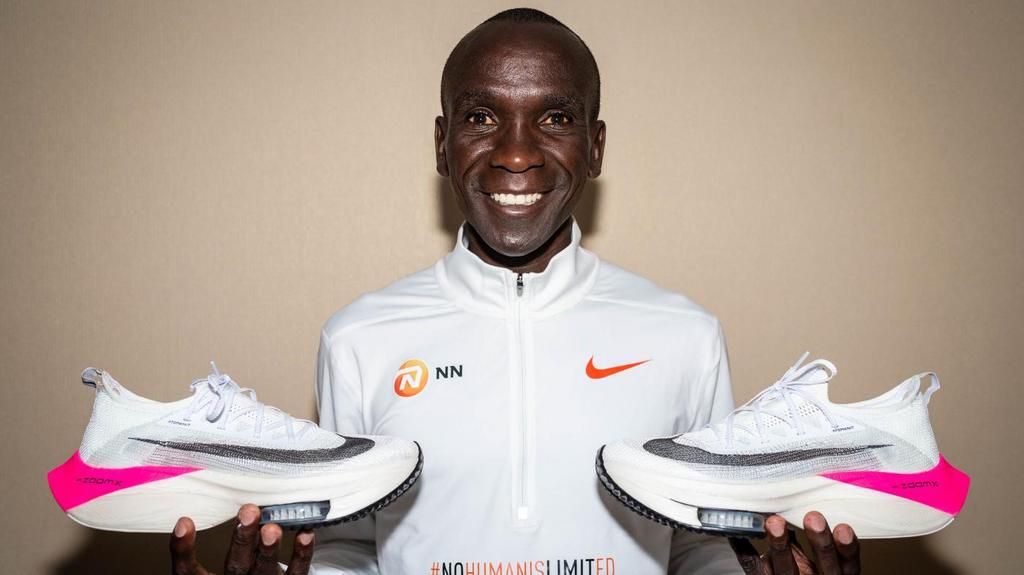 Eluid Kipchoge posing with the Alphafly Next% shoes