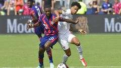 US defender Shaquell Moore, left, and Canada forward Tajon Buchanan battle for the ball during their CONCACAF Gold Cup match in Kansas City, Kansas