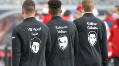Frankfurt players wear shirts with names and portraits of victims of the Hanau shootings which took place one year ago