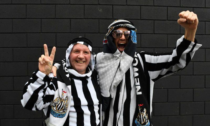 Newcastle fans pose in Arab-style clothing at St James' Park