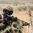 A Kenya Defence Forces (KDF) soldier, part of the African Mission in Somalia (AMISOM), secures an area during a foot patrol on the outskirts of the controlled area of the old airport in the coastal town of Kismayu in southern Somalia November 12, 2013....