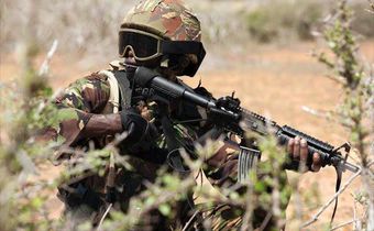 A Kenya Defence Forces (KDF) soldier, part of the African Mission in Somalia (AMISOM), secures an area during a foot patrol on the outskirts of the controlled area of the old airport in the coastal town of Kismayu in southern Somalia November 12, 2013....
