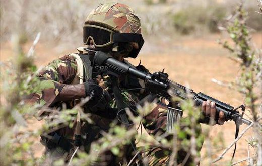 A Kenya Defence Forces (KDF) soldier, part of the African Mission in Somalia (AMISOM), secures an area during a foot patrol on the outskirts of the controlled area of the old airport in the coastal town of Kismayu in southern Somalia November 12, 2013....