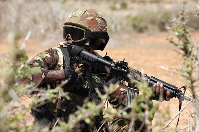 A Kenya Defence Forces (KDF) soldier, part of the African Mission in Somalia (AMISOM), secures an area during a foot patrol on the outskirts of the controlled area of the old airport in the coastal town of Kismayu in southern Somalia November 12, 2013....
