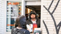 DETROIT, MICHIGAN - SEPTEMBER 29: Eminem serves Mom's Spaghetti to a fan on the opening night of his restaurant "Mom's Spaghetti" on September 29, 2021 in Detroit, Michigan. (Photo by Scott Legato/Getty Images)