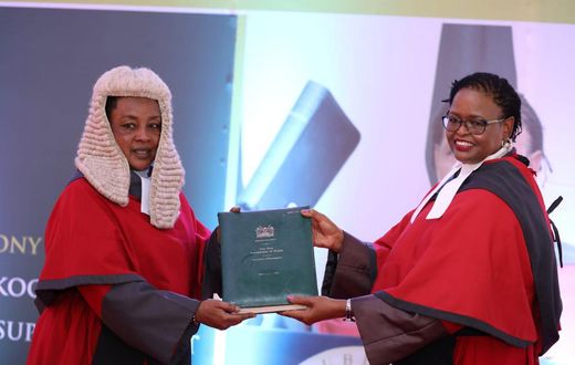Chief Justice Martha Karambu Koome receives instruments of power and the state of the Judiciary report from Deputy Chief Justice Philomena Mbete Mwilu