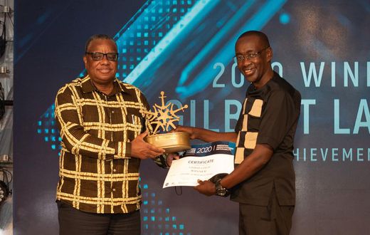 KPA Ag. Managing Director Amb. John Mwangemi (left) handing over certificate to winner of Lifetime Achievement Award Gilbert Langat at the EAMA 2020 Awards