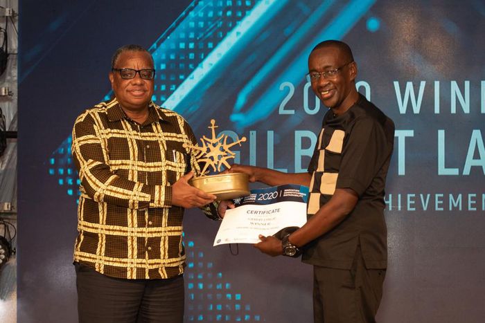 KPA Ag. Managing Director Amb. John Mwangemi (left) handing over certificate to winner of Lifetime Achievement Award Gilbert Langat at the EAMA 2020 Awards