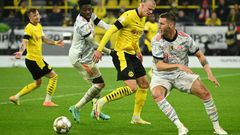 Bayern Munich defender Niklas Suele (R) managed to thwart Dortmund striker Erling Braut Haaland (C) on Tuesday in the German Super Cup