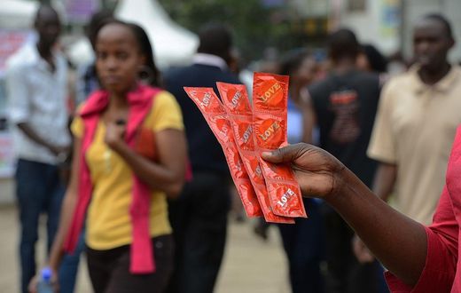 An Aids Healthcare Foundation-Kenya worker distributes condoms in the streets of Nairobi on February 14, 2014 to promote safe sex practices during the Valentine week and to mark the International Condom Day. A non-governmental organisation is planning ...