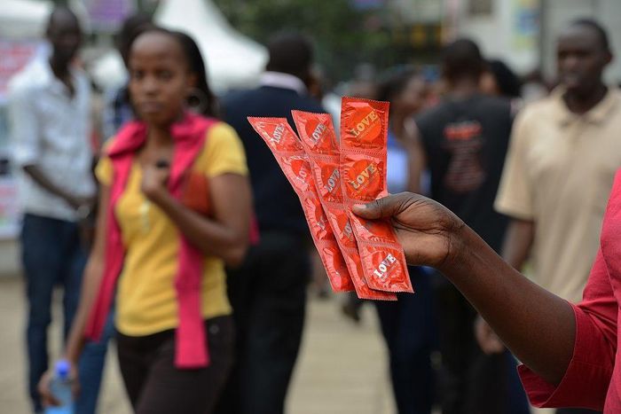 An Aids Healthcare Foundation-Kenya worker distributes condoms in the streets of Nairobi on February 14, 2014 to promote safe sex practices during the Valentine week and to mark the International Condom Day. A non-governmental organisation is planning ...