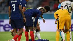 France's defender Benjamin Pavard (C) was hurt in a collision with German defender Robin Gosens