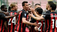 Mario Mandzukic (C) returned from injury as Milan ended their two-month home drought against Genoa.