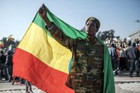 A man wearing holds an Ethiopian flag during a rally in Addis Ababa, Ethiopia, on November 7, 2021, in support of the national defense forces. - Five days after the government declared a state of emergency throughout the country, tens of thousands of Ethiopians vowed at a pro-government rally in Addis Ababa on November 7 to defend the capital against Tigrayan rebels and denounced diplomatic efforts to end the conflict in the north of the country. Photo by EDUARDO SOTERAS/AFP via Getty Images