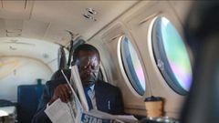 ODM leader Raila Odinga reading a newspaper in a plane