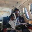 ODM leader Raila Odinga reading a newspaper in a plane