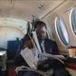 ODM leader Raila Odinga reading a newspaper in a plane