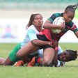 Madagascar players vie for the ball against Kenya's Terry Ayetsa (wearing red) during the Rugby Africa Women's Cup finals at Nyayo Stadium, Nairobi on July 11 2021.