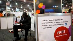 FILE PHOTO: A job-seeker completes an application at a career job fair in Philadelphia, Pennsylvania, U.S. July 25, 2013.  REUTERS/Mark Makela/File Photo   GLOBAL BUSINESS WEEK AHEAD