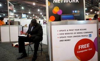 FILE PHOTO: A job-seeker completes an application at a career job fair in Philadelphia, Pennsylvania, U.S. July 25, 2013.  REUTERS/Mark Makela/File Photo   GLOBAL BUSINESS WEEK AHEAD