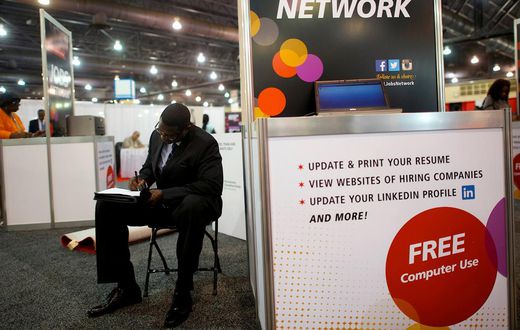 FILE PHOTO: A job-seeker completes an application at a career job fair in Philadelphia, Pennsylvania, U.S. July 25, 2013.  REUTERS/Mark Makela/File Photo   GLOBAL BUSINESS WEEK AHEAD