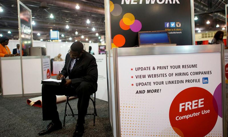 FILE PHOTO: A job-seeker completes an application at a career job fair in Philadelphia, Pennsylvania, U.S. July 25, 2013.  REUTERS/Mark Makela/File Photo   GLOBAL BUSINESS WEEK AHEAD
