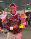 Martin Shabaya displays his fifth place trophy at World Coffee Championship