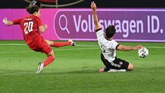 Denmark forward Yussuf Poulsen (L) scores the equaliser against Germany