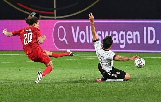 Denmark forward Yussuf Poulsen (L) scores the equaliser against Germany