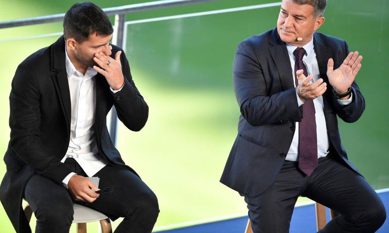 A tearful Sergio Aguero (L) with Barcelona president Joan Laporta at a press conference at the Camp Nou to announce his retirement from football on Wednesday